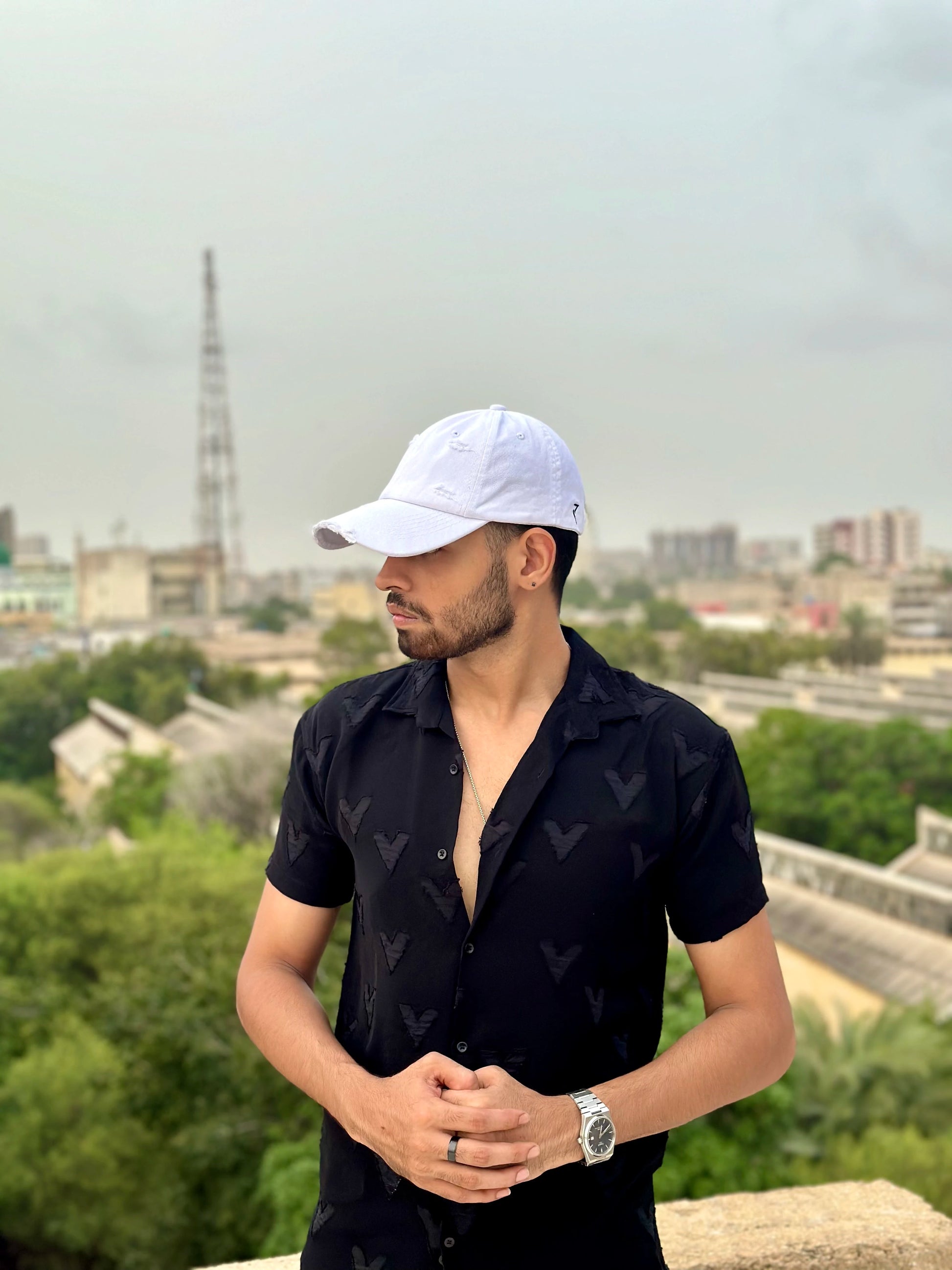 Model wearing white ripped cap