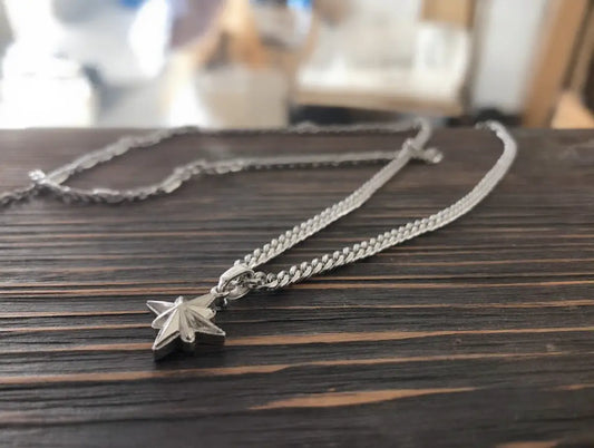 Necklace with a star-shaped pendant on a wooden surface